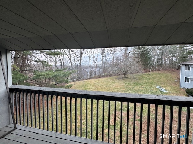 74 Buddington Road, Unit 7 Groton, CT 06340 - Photo 5 of 19 a view of roof deck with wooden floor and fence