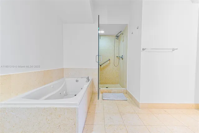 a bathroom with a bathtub and a shower