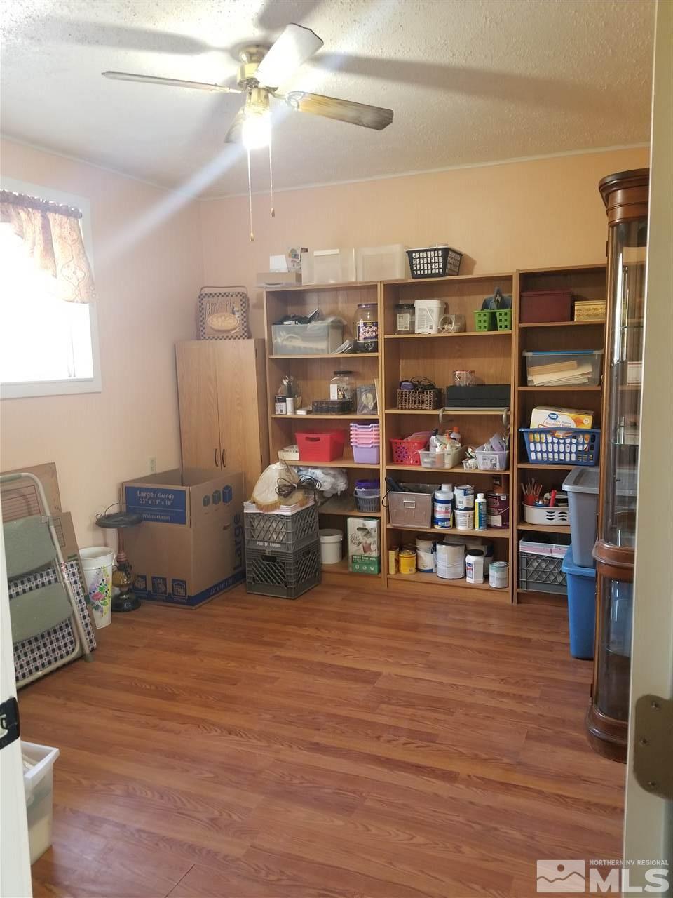 2555 Soda Lake Road Fallon, NV 89406 - Photo 31 of 40 a room with furniture and a wooden floor
