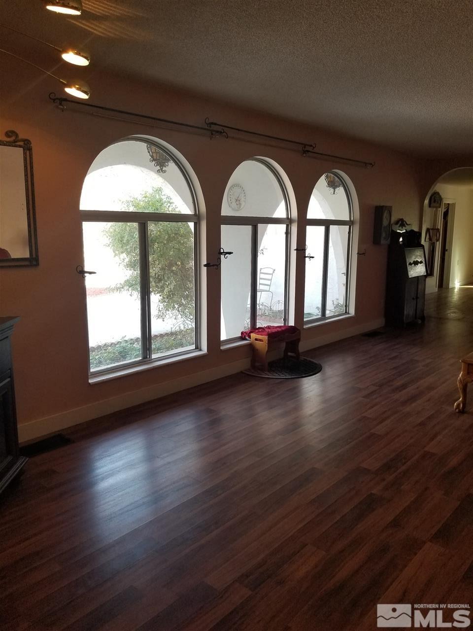 2555 Soda Lake Road Fallon, NV 89406 - Photo 6 of 40 a view of empty room with wooden floor and fan