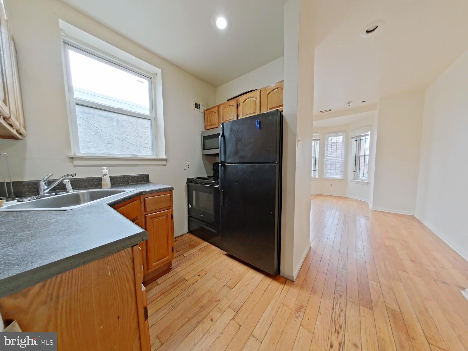 1422 Willington Street, Unit 2 Philadelphia, PA 19121 - Photo 11 of 25 a kitchen with wooden floors appliances and a window