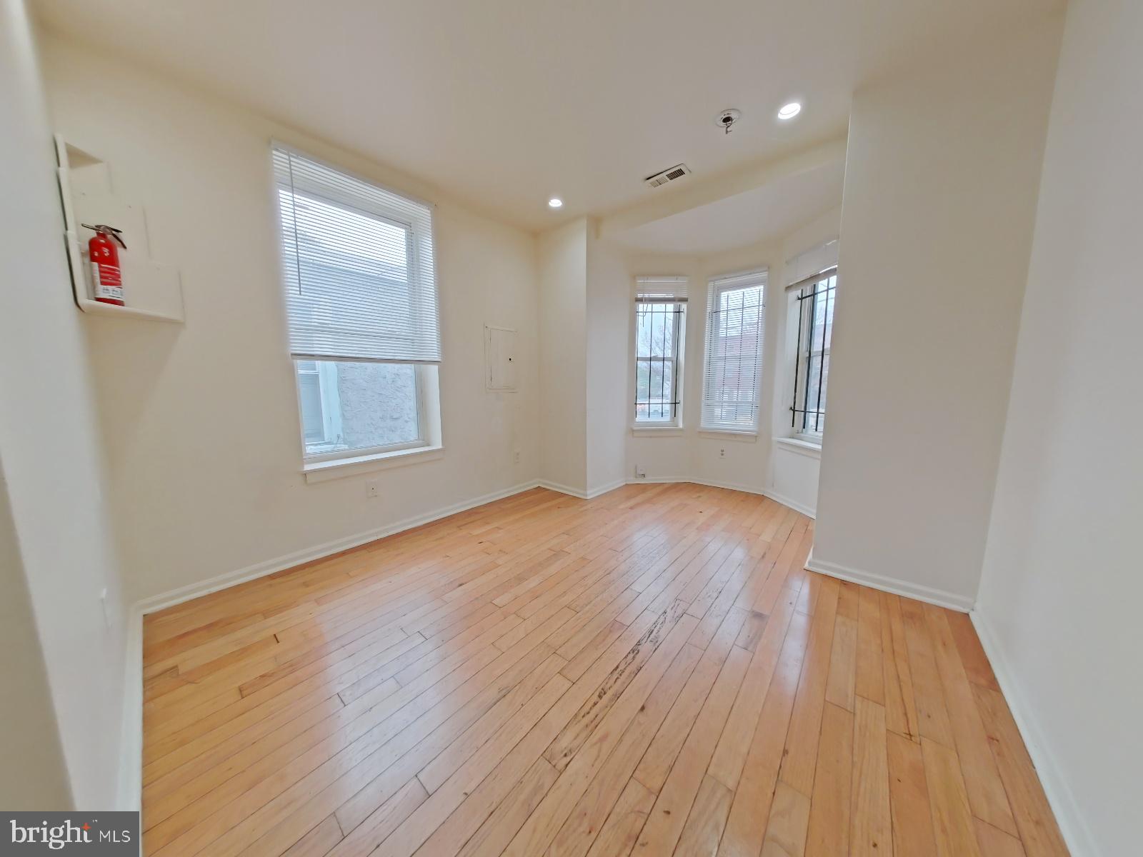 1422 Willington Street, Unit 2 Philadelphia, PA 19121 - Photo 13 of 25 an empty room with wooden floor and windows