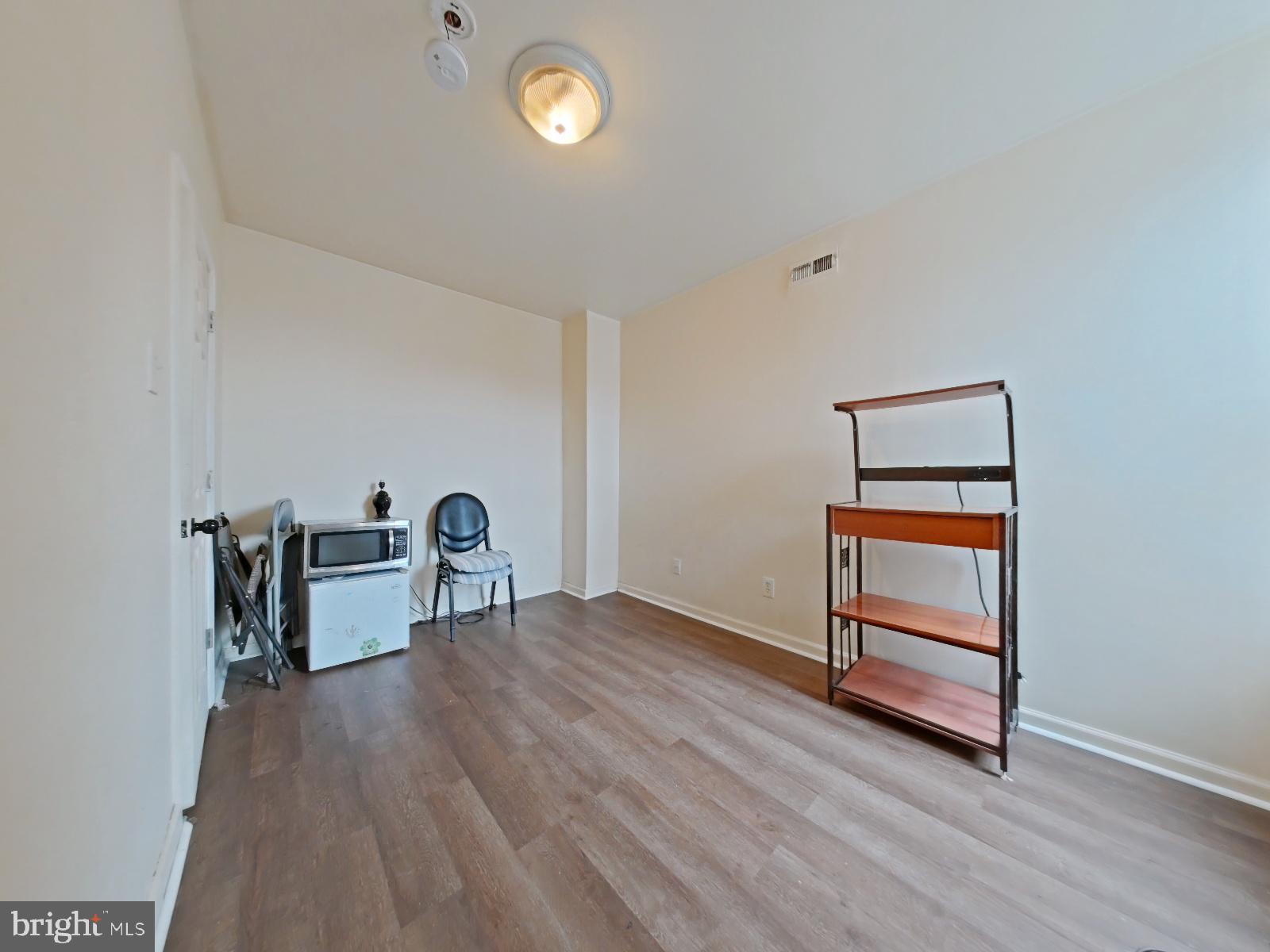 1422 Willington Street, Unit 2 Philadelphia, PA 19121 - Photo 17 of 25 a view of room with window and wooden floor