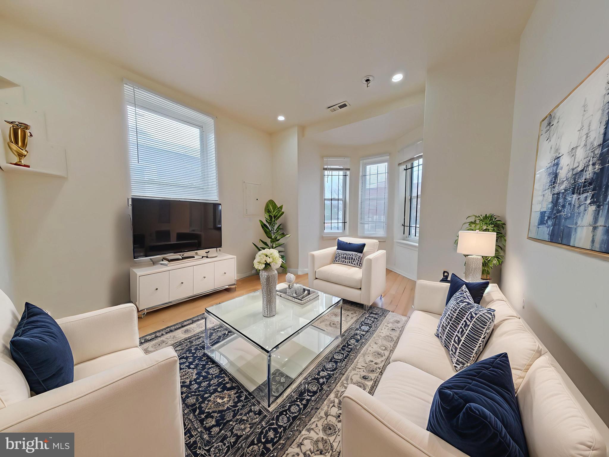 1422 Willington Street, Unit 2 Philadelphia, PA 19121 - Photo 2 of 25 a living room with furniture a flat screen tv and a couch