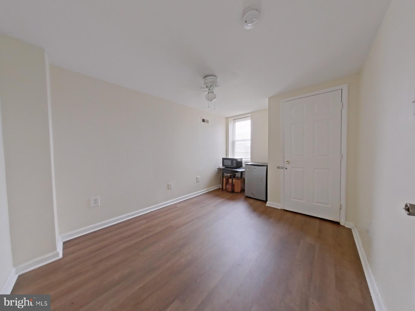 1422 Willington Street, Unit 2 Philadelphia, PA 19121 - Photo 22 of 25 an empty room with wooden floor and windows