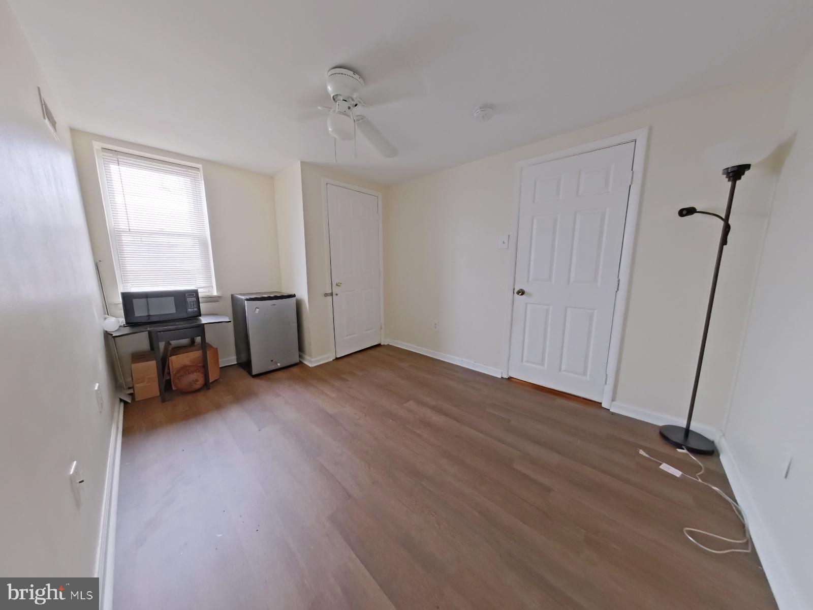 1422 Willington Street, Unit 2 Philadelphia, PA 19121 - Photo 23 of 25 a view of empty room with wooden floor and fan