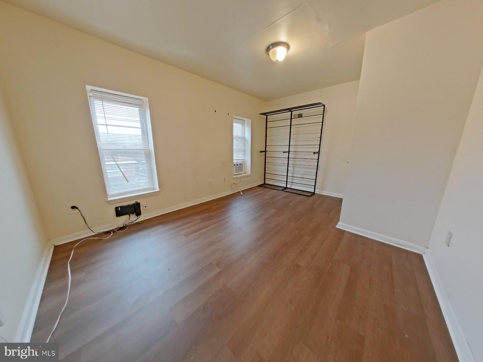 1422 Willington Street, Unit 2 Philadelphia, PA 19121 - Photo 24 of 25 an empty room with wooden floor and windows
