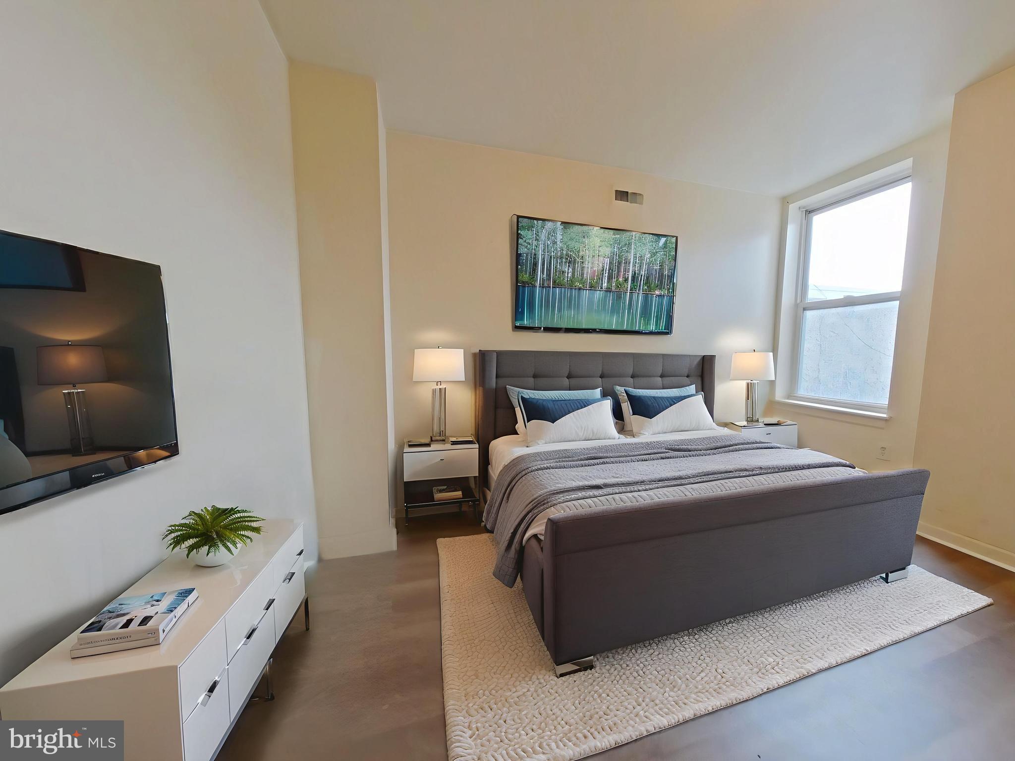 1422 Willington Street, Unit 2 Philadelphia, PA 19121 - Photo 4 of 25 a bedroom with a bed and a flat tv screen on dresser