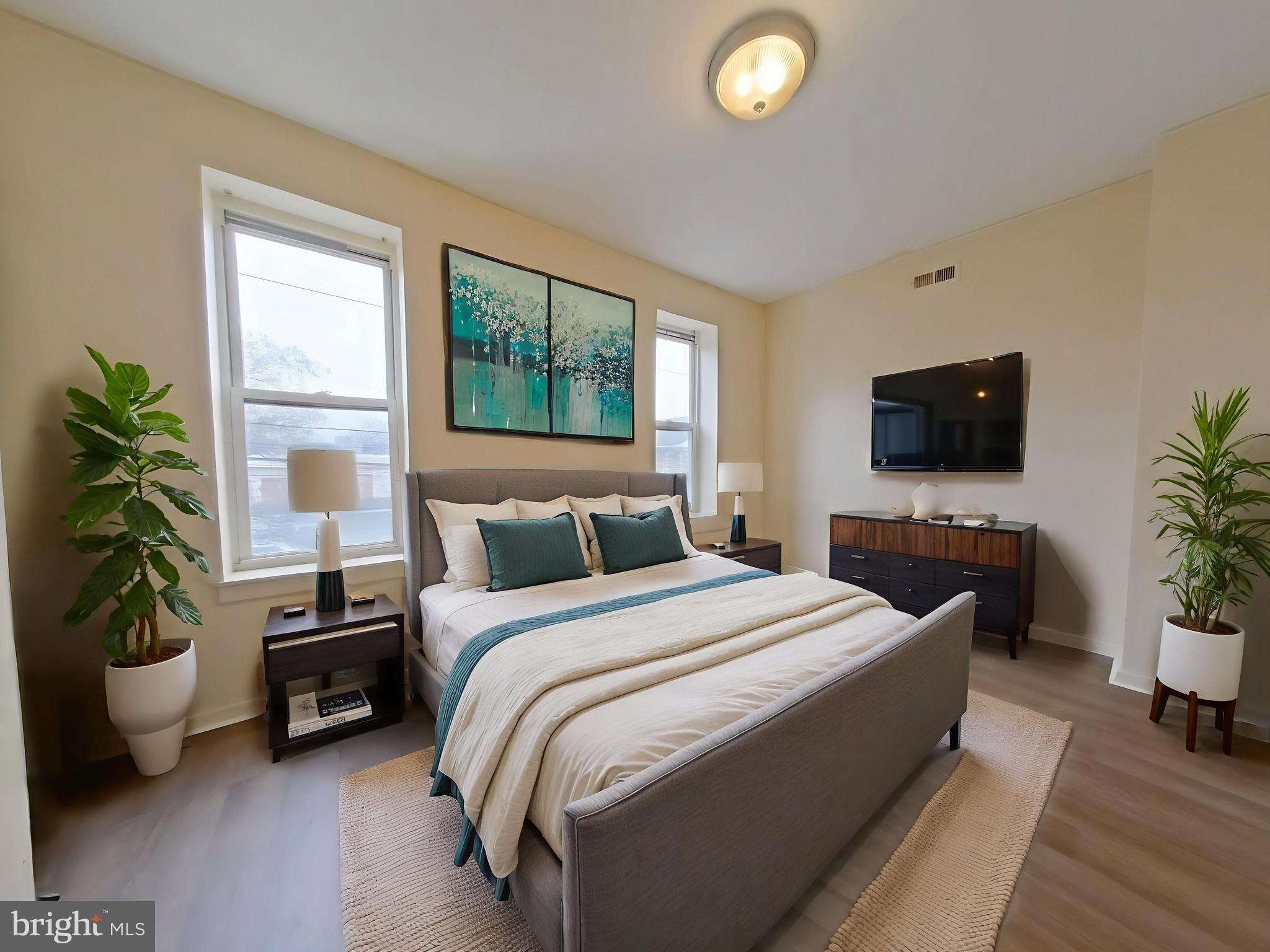 1422 Willington Street, Unit 2 Philadelphia, PA 19121 - Photo 5 of 25 a bedroom with a bed and a flat screen tv