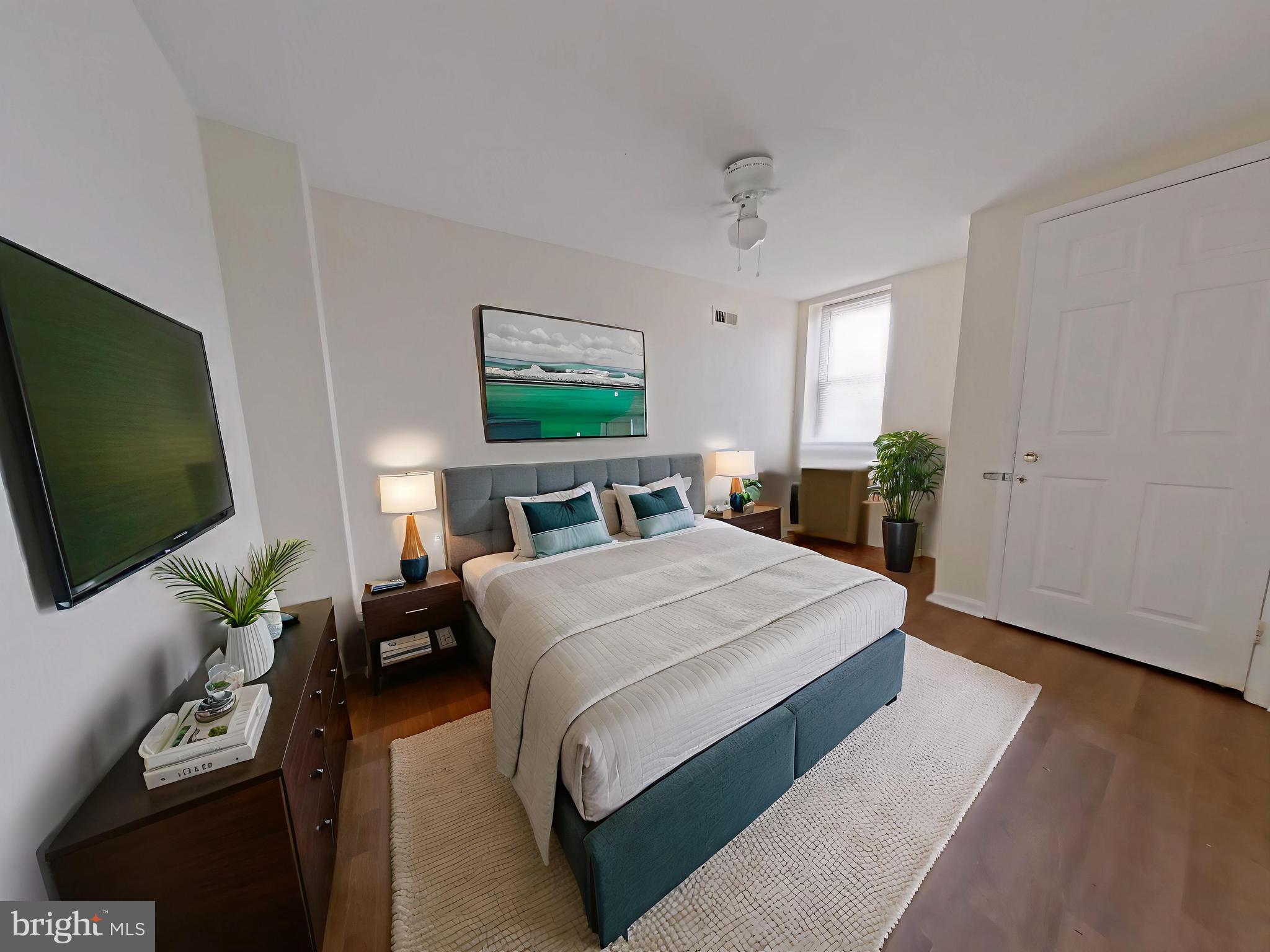 1422 Willington Street, Unit 2 Philadelphia, PA 19121 - Photo 6 of 25 a spacious bedroom with a bed and a flat screen tv