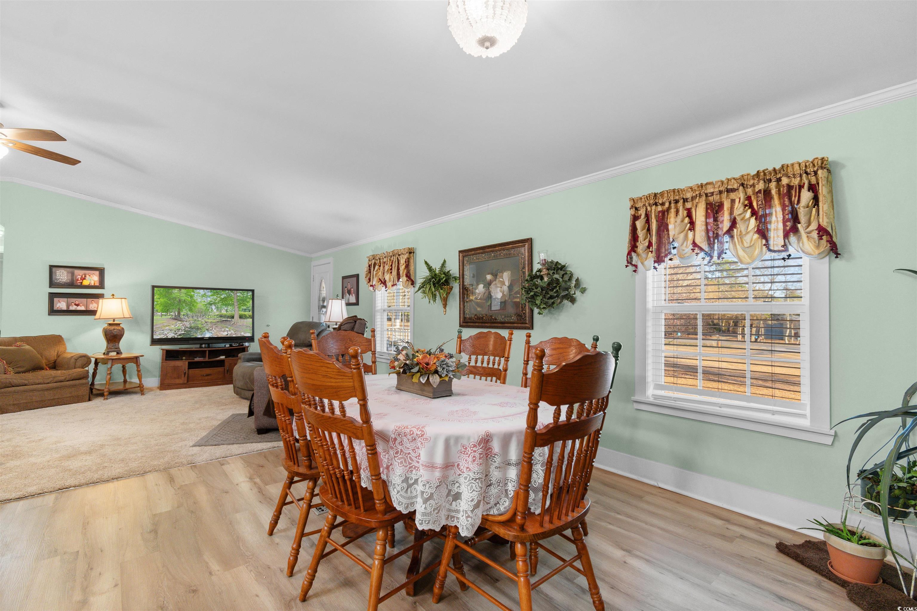 4065 Highway 66 Loris, SC 29569 - Photo 13 of 40 Dining area featuring light wood finished floors, lofted ceiling, ornamental molding, and ceiling fan