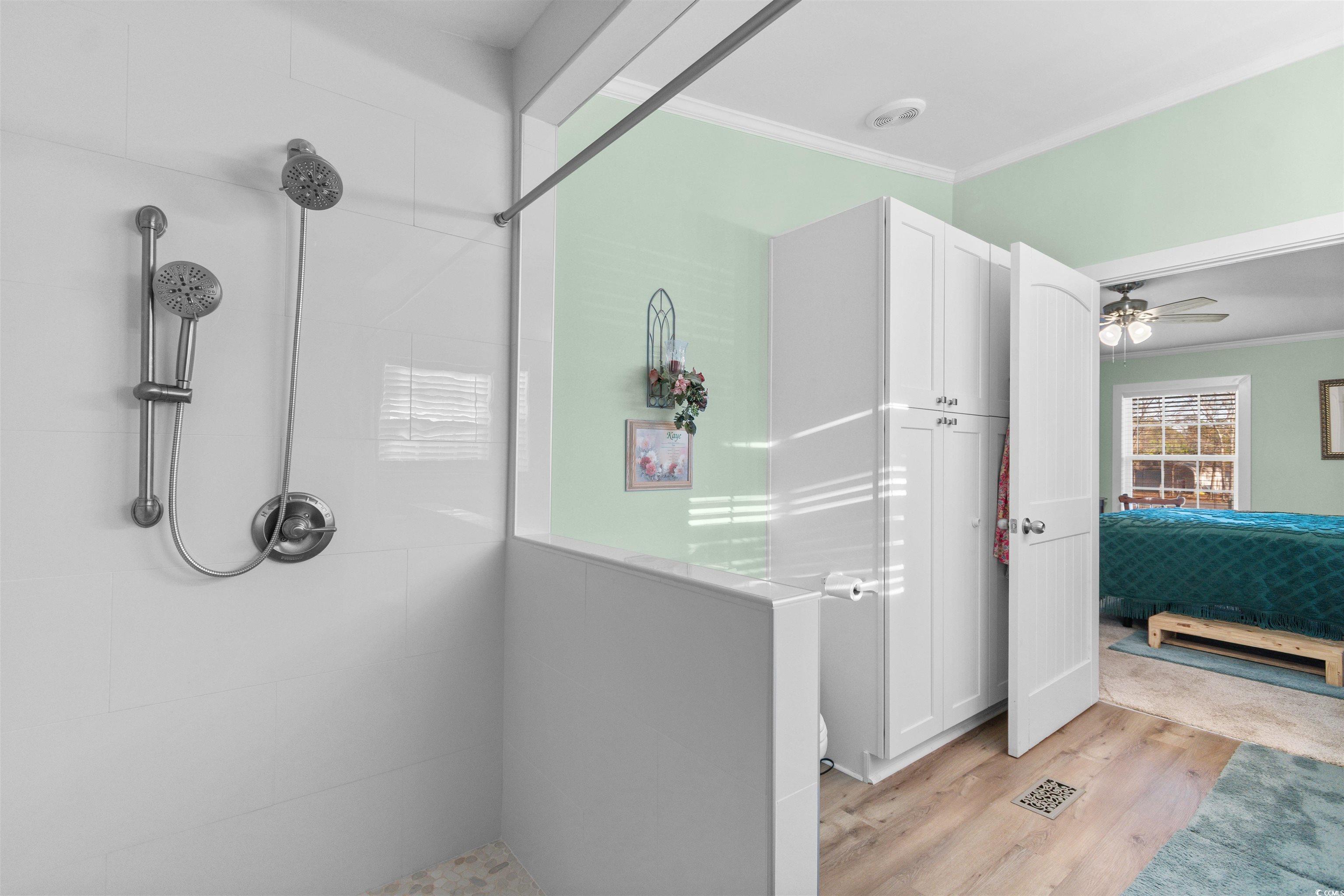 4065 Highway 66 Loris, SC 29569 - Photo 17 of 40 Ensuite bathroom featuring crown molding, light wood finished floors, walk in shower, and ceiling fan