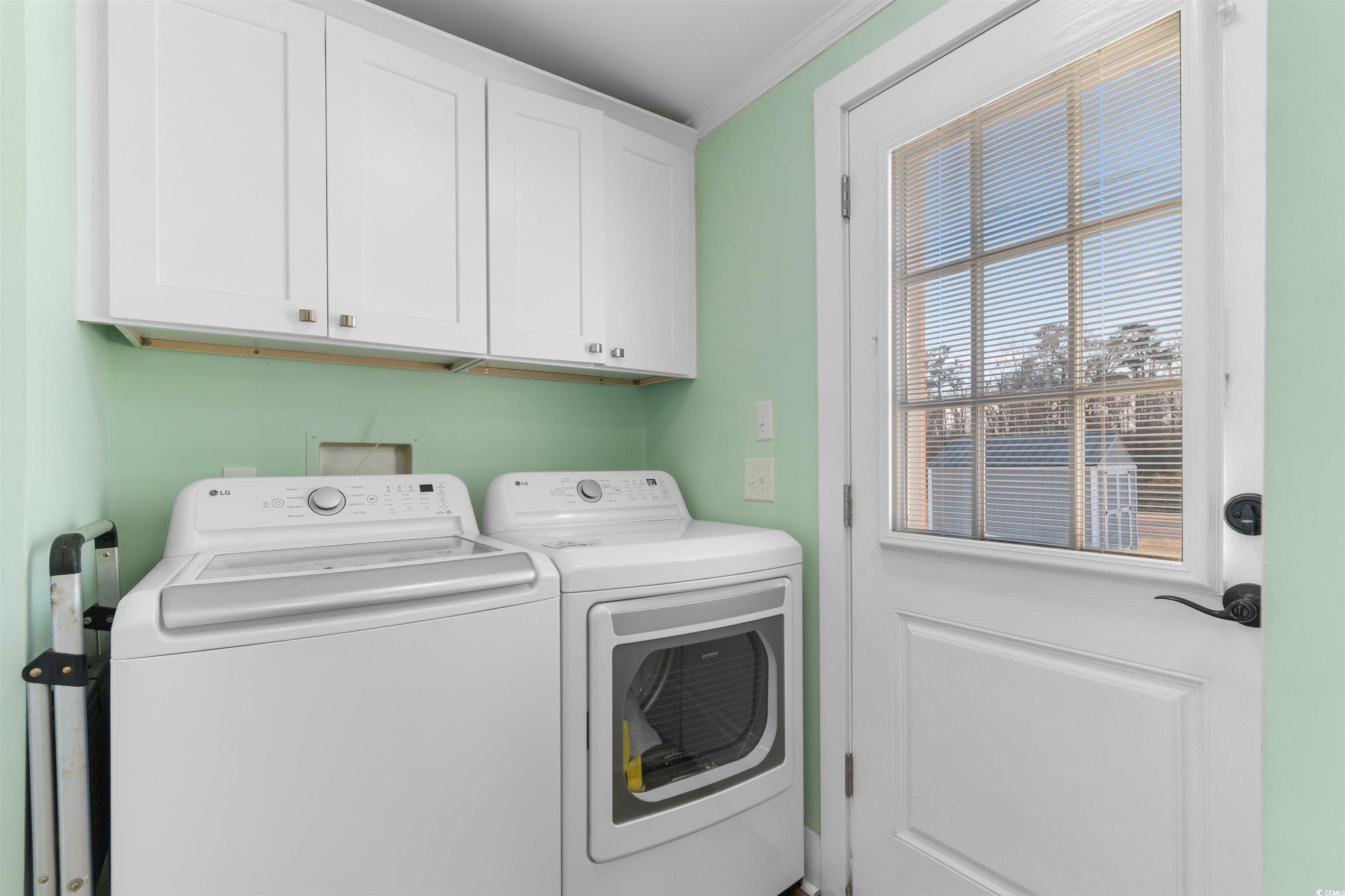4065 Highway 66 Loris, SC 29569 - Photo 24 of 40 Laundry room featuring cabinet space, separate washer and dryer, and crown molding