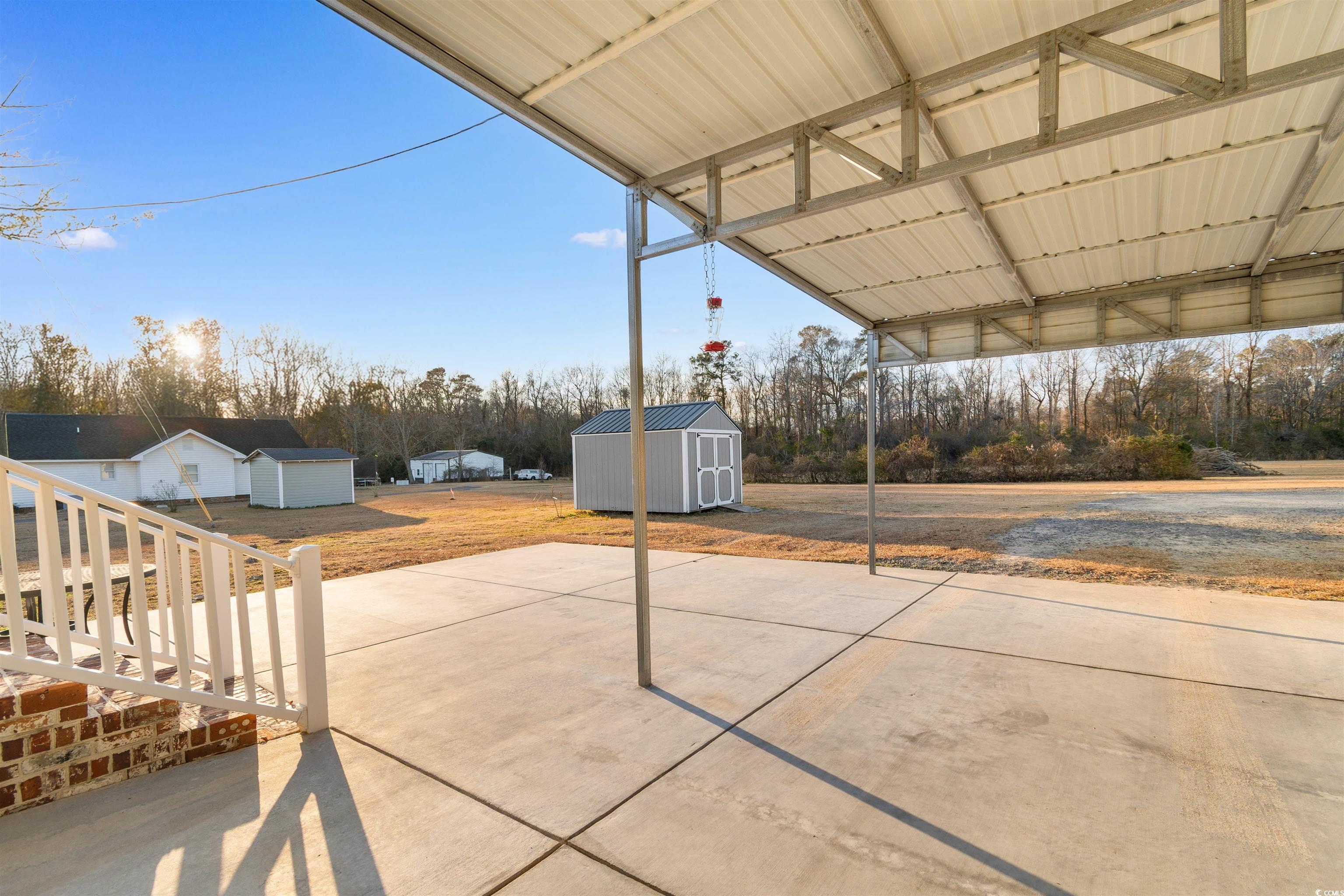4065 Highway 66 Loris, SC 29569 - Photo 27 of 40 View of patio / terrace featuring a storage shed