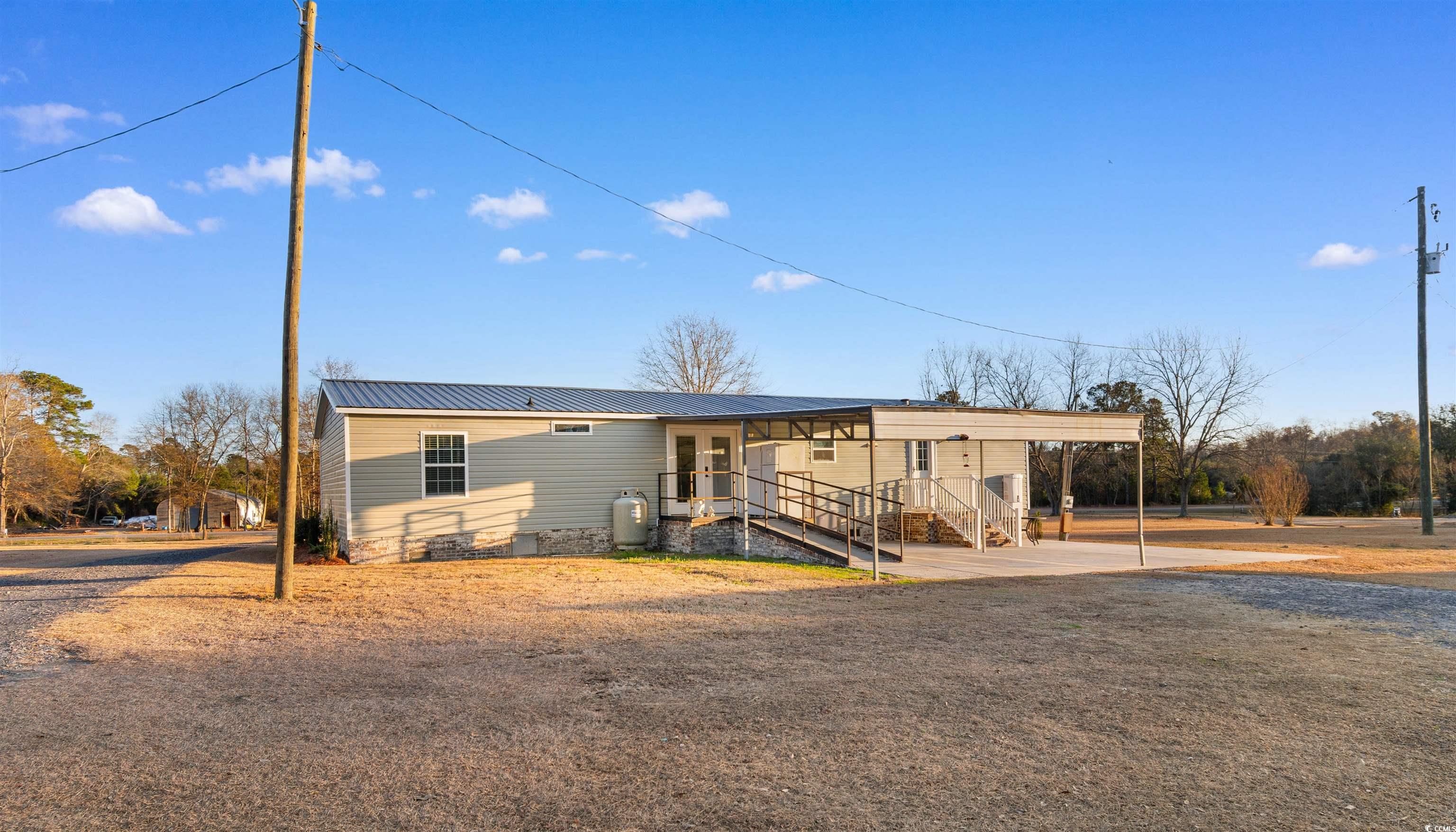 4065 Highway 66 Loris, SC 29569 - Photo 33 of 40 Rear view of property featuring a metal roof and an attached carport