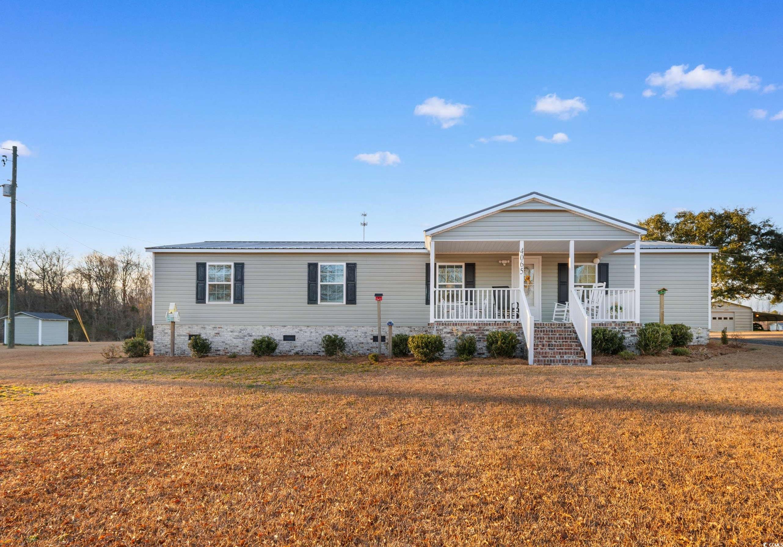 4065 Highway 66 Loris, SC 29569 - Photo 36 of 40 Manufactured / mobile home featuring a porch, a front yard, stairs, and crawl space