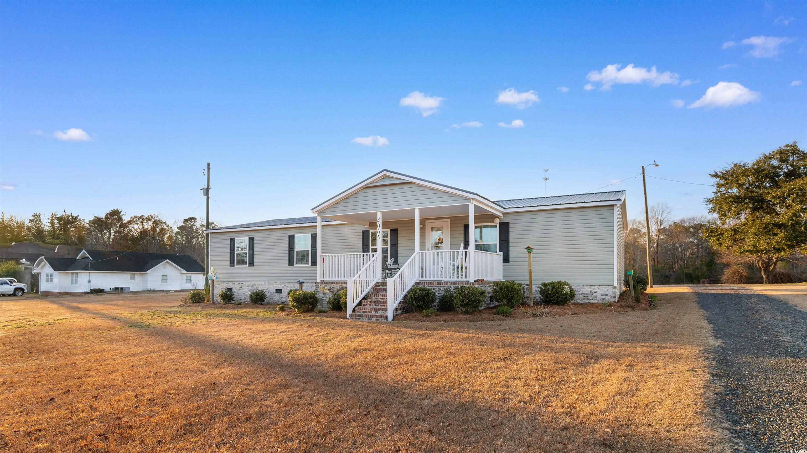 4065 Highway 66 Loris, SC 29569 - Photo 37 of 40 Manufactured / mobile home featuring a porch, a front yard, and crawl space