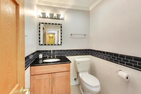 a bathroom with a toilet sink and mirror