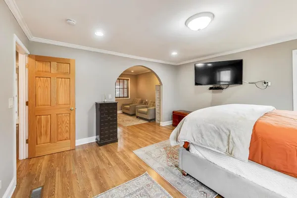a bedroom with a bed and a flat screen tv