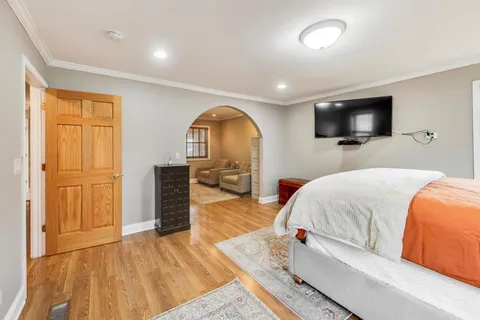 a bedroom with a bed and a flat screen tv