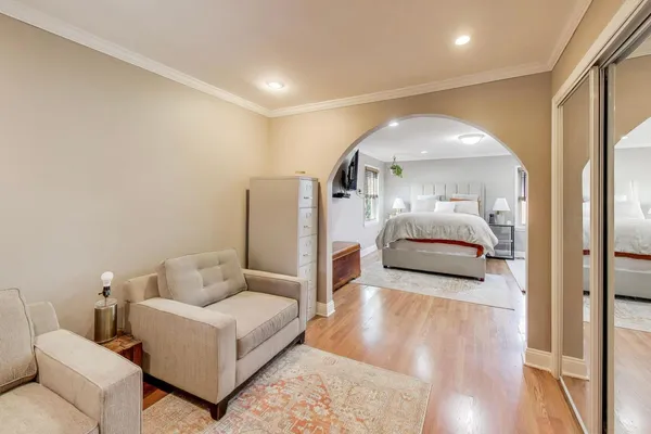 a living room with furniture and a mirror