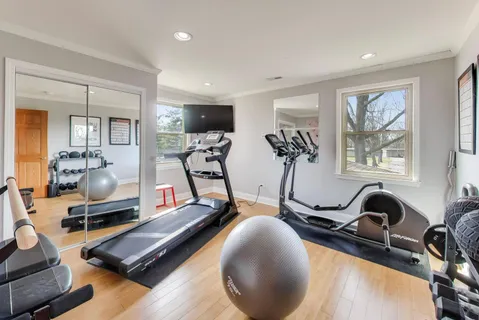 a room with gym equipment and windows