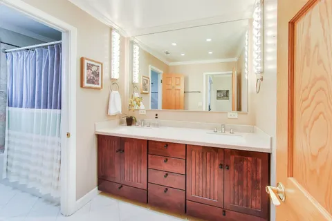 a bathroom with a double vanity sink and a mirror