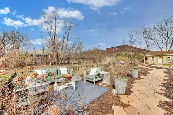 a backyard of a house with table and chairs