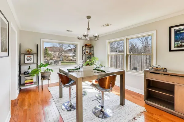 a view of a dining room with furniture window and wooden floor