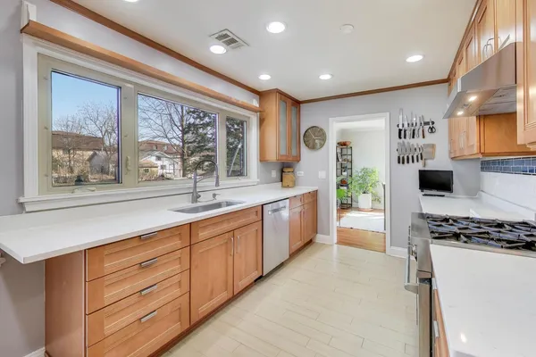a kitchen with stainless steel appliances granite countertop a stove a sink and a refrigerator