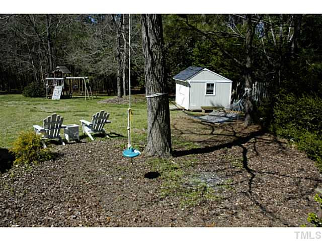12613 Waterman Drive Raleigh, NC 27614 - Photo 24 of 25 View of other area of backyard. Storage shed is included. Nice for yard tools. Play equipment included too! How about napping on the hammock! Back Yard