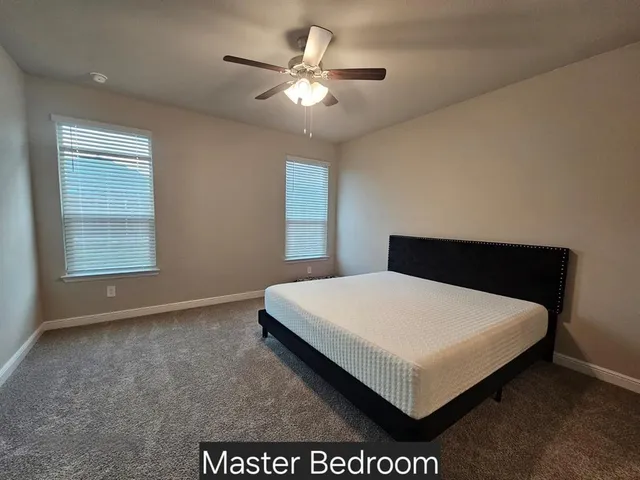 a bed sitting in a bedroom next to a window