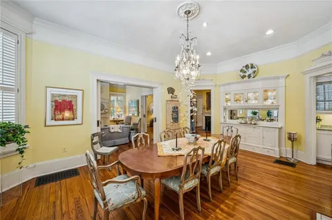 a view of a dining room with furniture wooden floor and chandelier