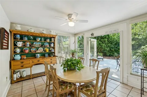 a dining room with furniture a chandelier and window