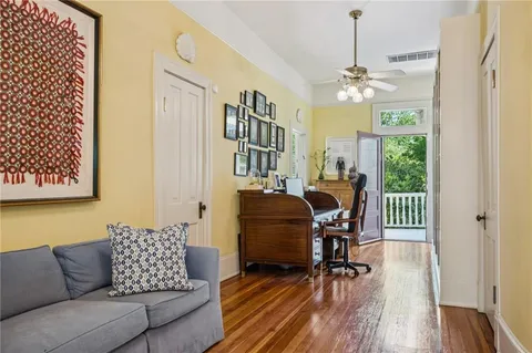 a work room with furniture wooden floor and a chandelier