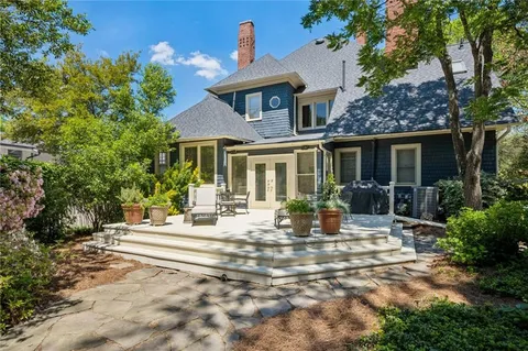 a view of house with yard and outdoor seating
