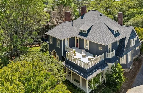 front view of a brick house with a yard