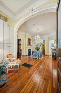 a living room with furniture and a wooden floor