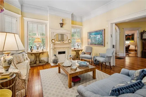 a living room with furniture large window and a table