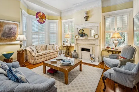 a living room with furniture kitchen view and a fireplace