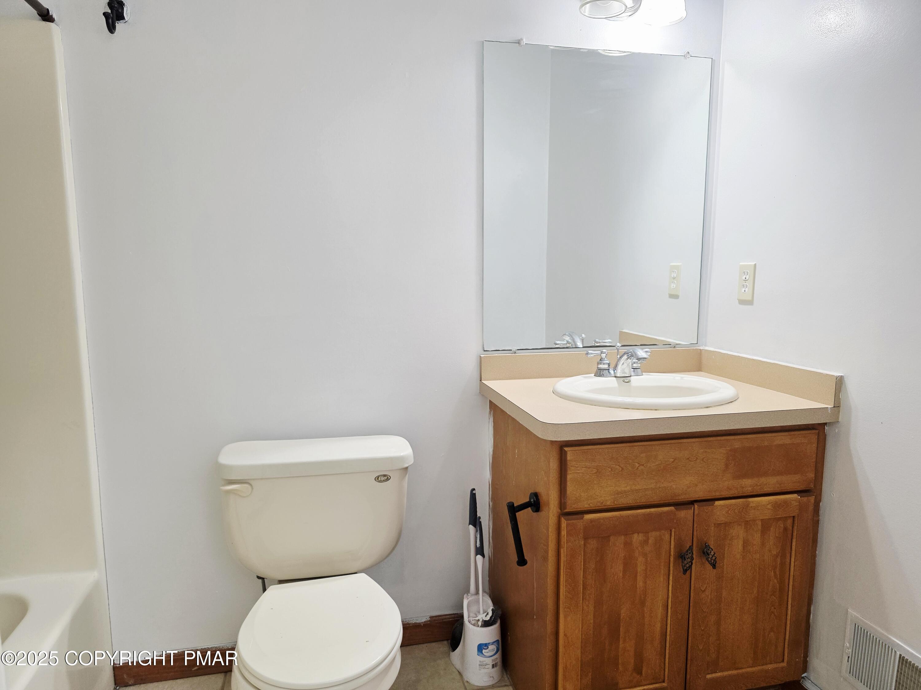 1001 Long Lake Road Tamiment, PA 18371 - Photo 14 of 38 a bathroom with a toilet sink and mirror