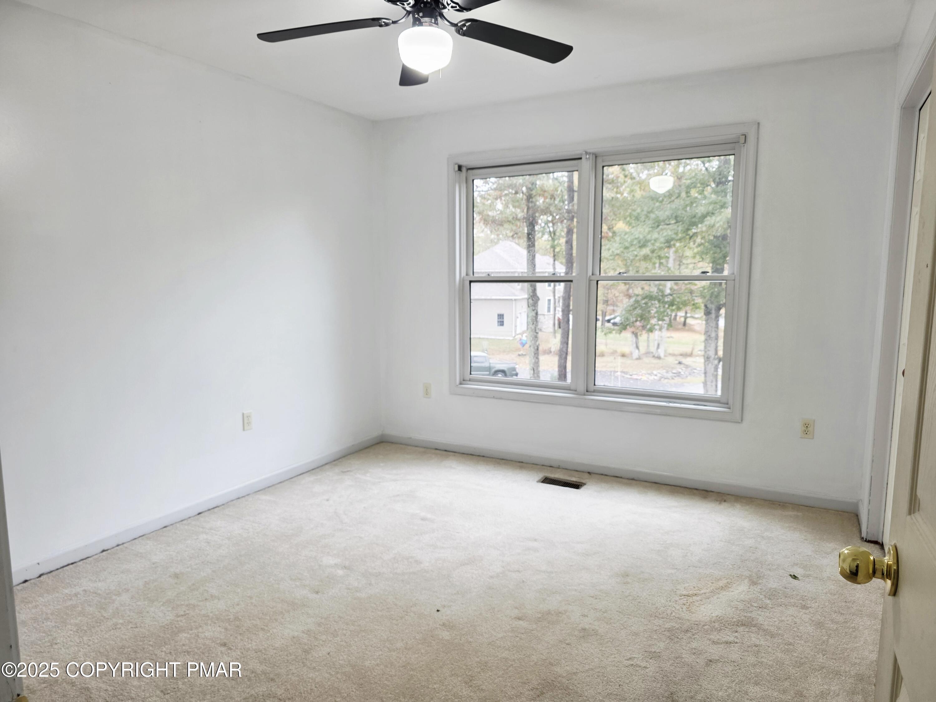 1001 Long Lake Road Tamiment, PA 18371 - Photo 15 of 38 an empty room with windows and fan
