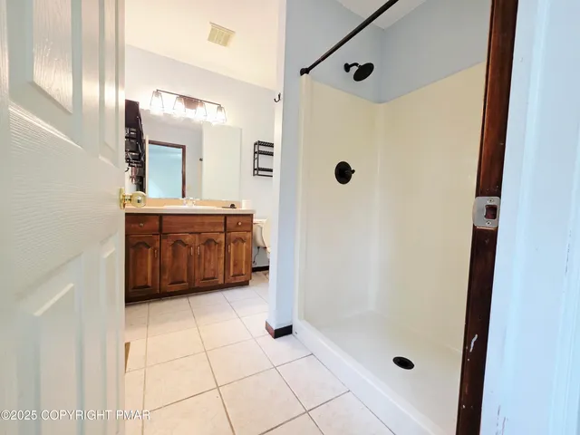 a bathroom with a bathtub and a shower