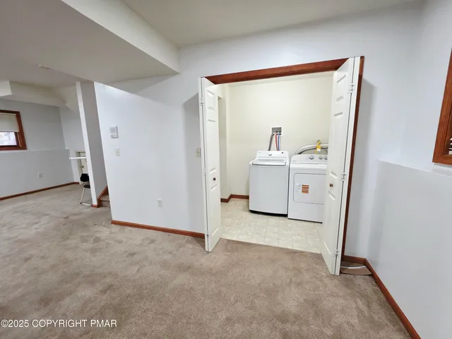 a view of a big room with closet and front door