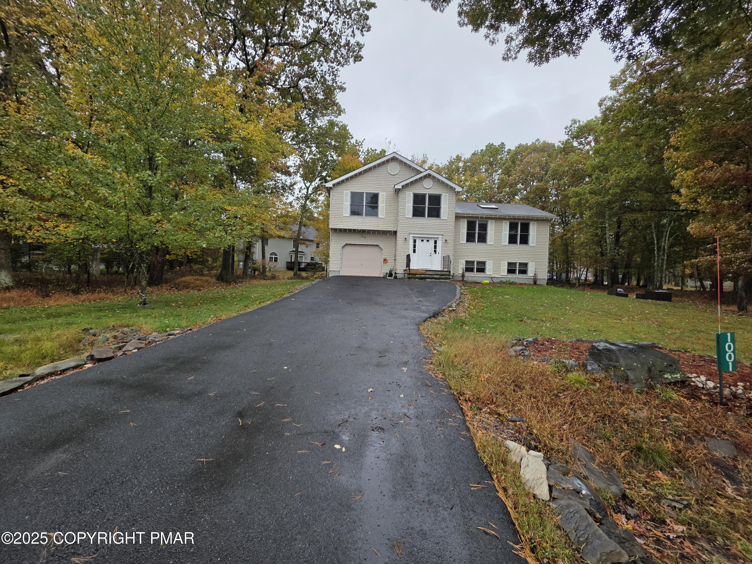 1001 Long Lake Road Tamiment, PA 18371 - Photo 35 of 38 a front view of a house with a yard and trees