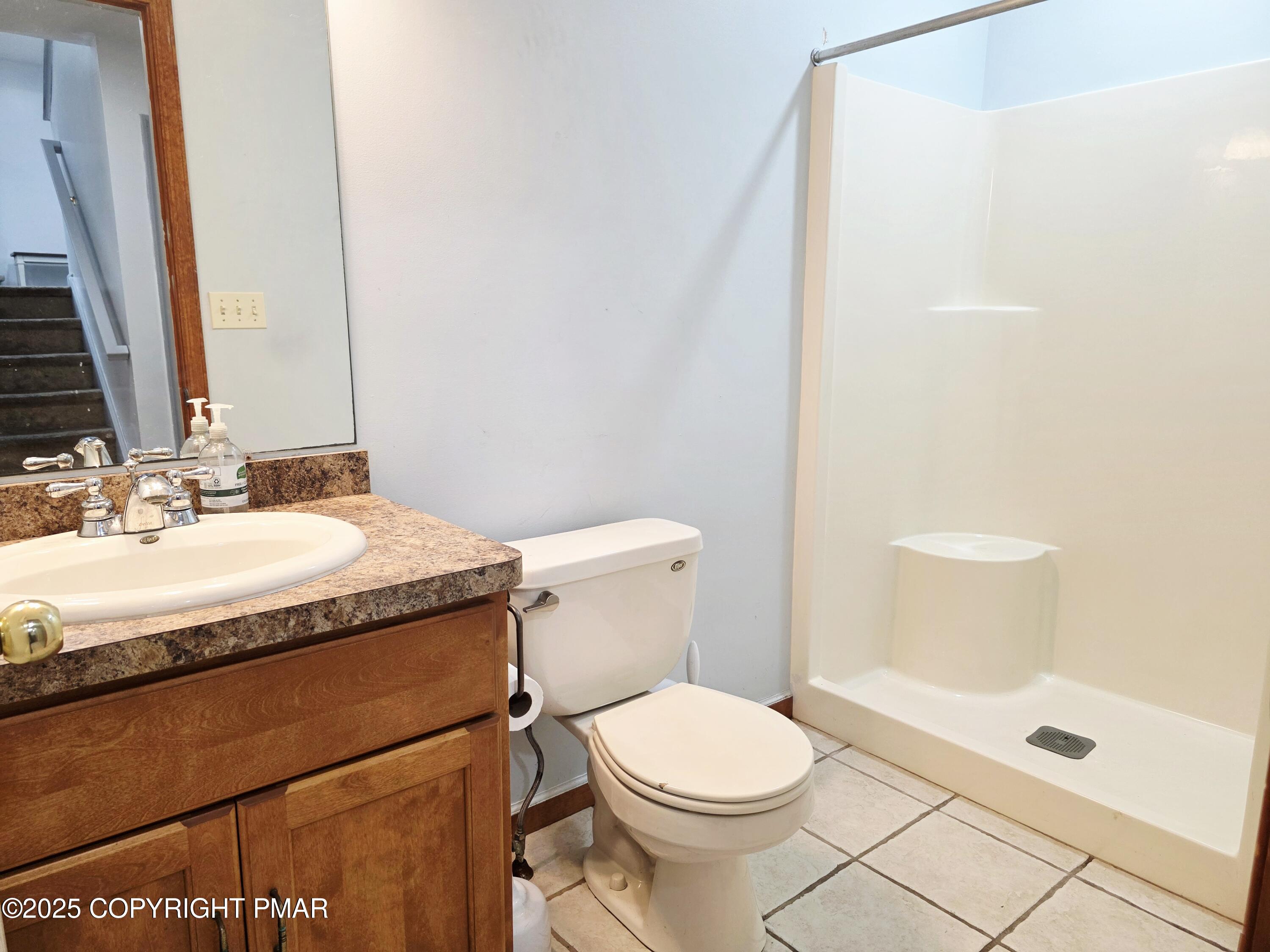 1001 Long Lake Road Tamiment, PA 18371 - Photo 4 of 38 a bathroom with a granite countertop sink a toilet and shower