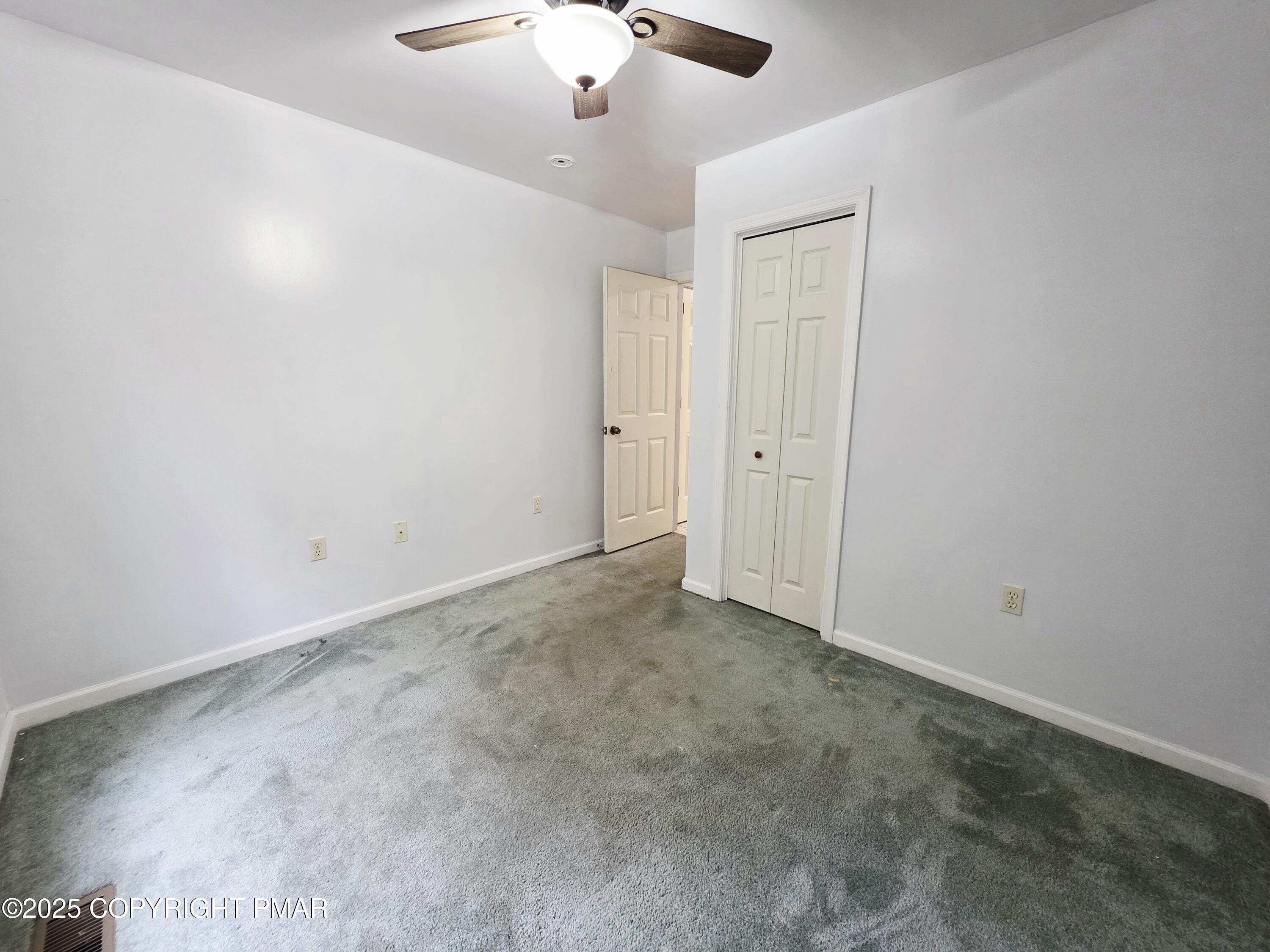 1001 Long Lake Road Tamiment, PA 18371 - Photo 6 of 38 an empty room with a chandelier fan