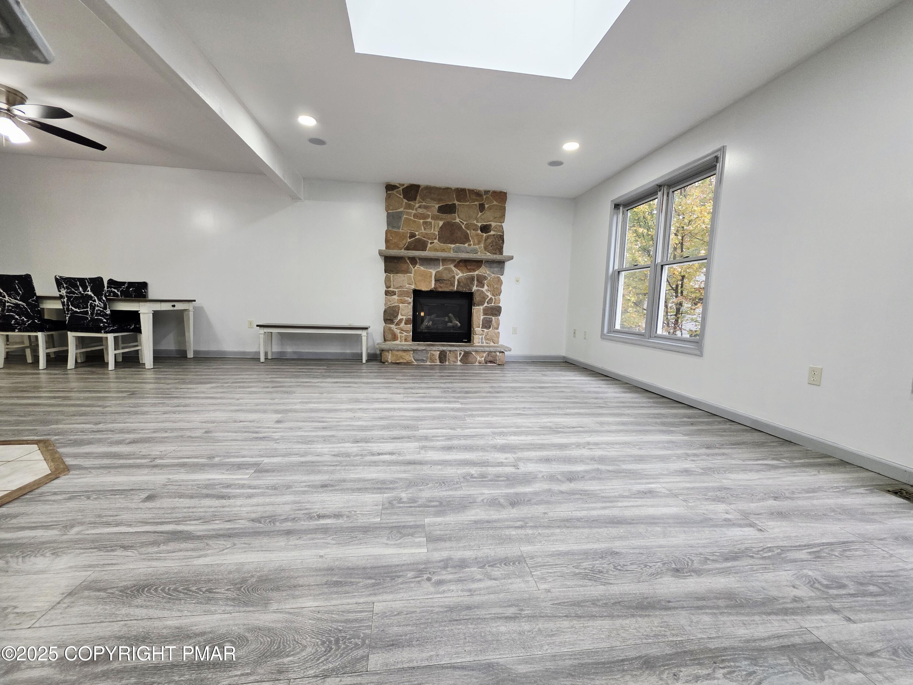 1001 Long Lake Road Tamiment, PA 18371 - Photo 8 of 38 a view of an empty room with window and fireplace