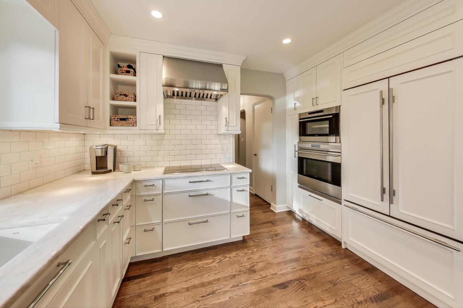 2121 Fir Street Glenview, IL 60025 - Photo 8 of 28 a kitchen with stainless steel appliances a stove a sink and a refrigerator