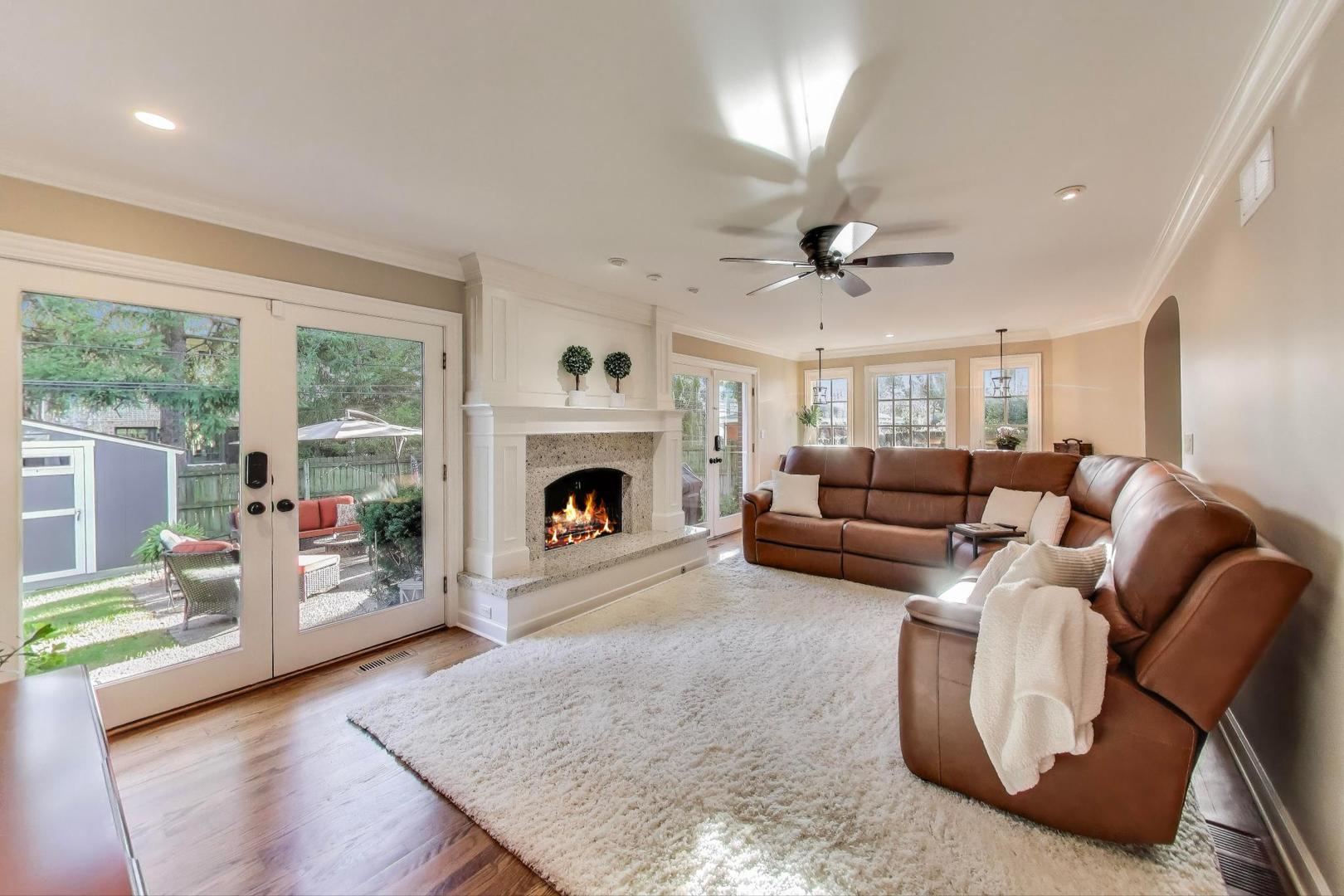 2121 Fir Street Glenview, IL 60025 - Photo 10 of 28 a living room with furniture large window and a fireplace